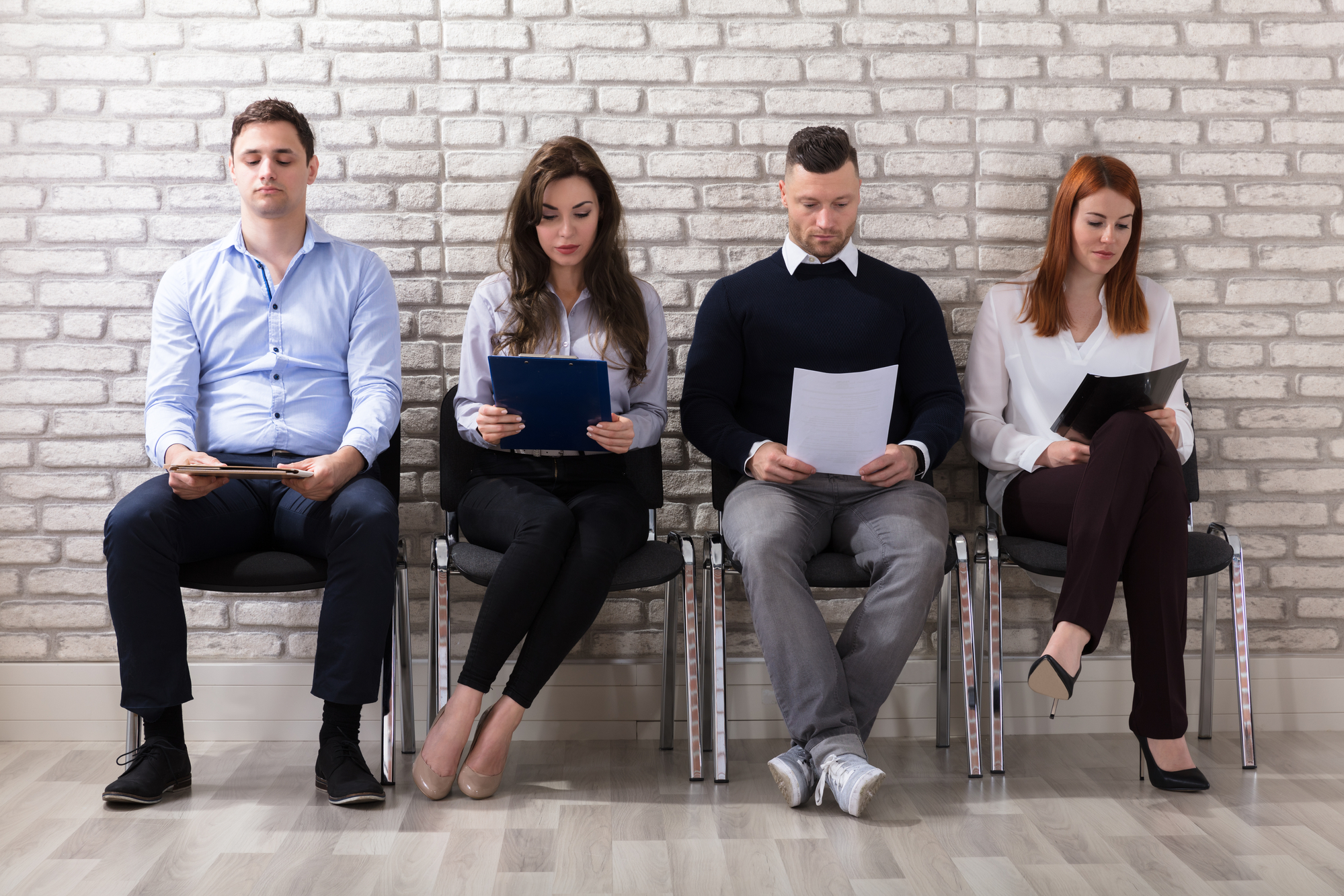 Group Of People Sitting On Chair Waiting For Job Interview In Office