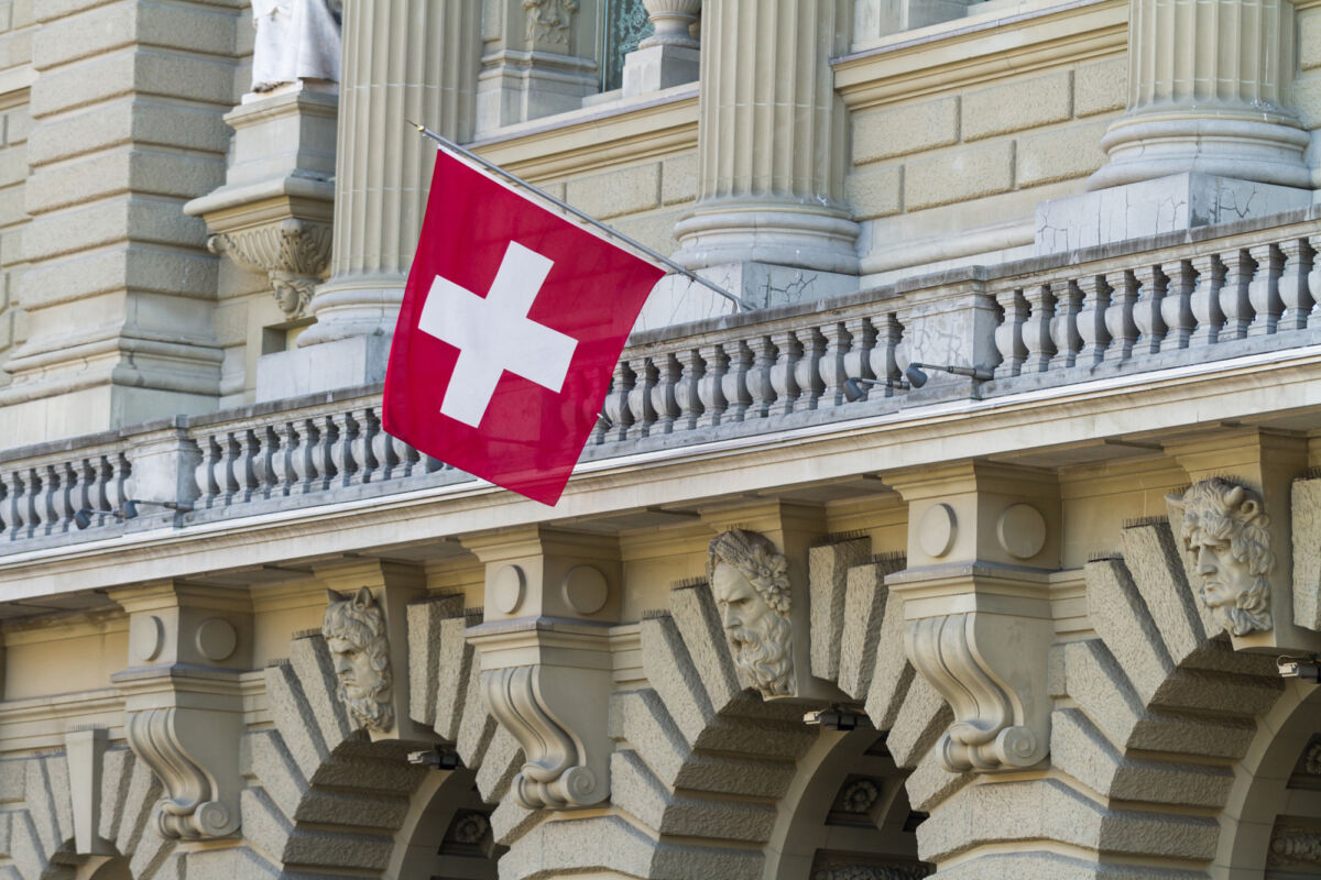 Bundeshaus Facade with Swiss Flag in Bern, Switzerland