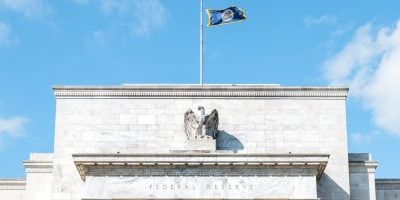 Washington DC, USA - March 9, 2018: Closeup of Federal Reserve bank facade entrance, architecture building, eagle statue American flags, blue sky at sunny day