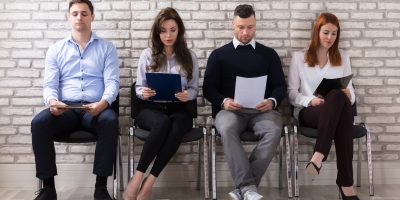 Group Of People Sitting On Chair Waiting For Job Interview In Office