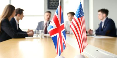 Diversity people talk the international conference partnership. American flag and British flag
