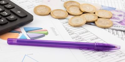 Monthly budget spreadsheet, money, pen and calculator