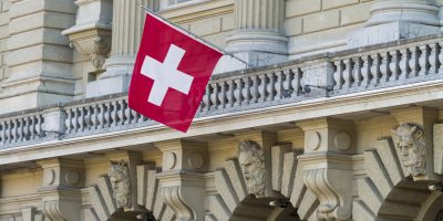 Bundeshaus Facade with Swiss Flag in Bern, Switzerland