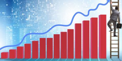 Businessman climbing towards growth in statistics