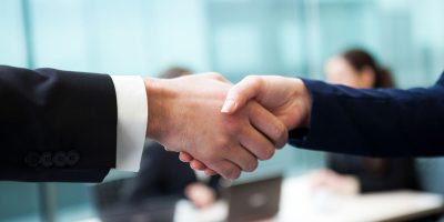 Business handshake and business people at the office