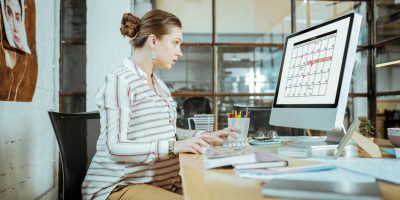 Overloaded and busy. Pregnant businesswoman feeling overloaded and busy checking her schedule