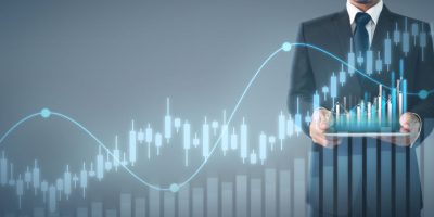 Businessman plan graph growth and increase of chart positive indicators in his business,tablet in hand