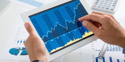 Close Up Of A Businessman Analyzing Graph On Digital Tablet