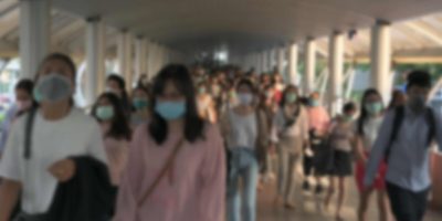 Blured defocused. The crowd is wearing protective masks prevent Coronavirus, Covid 19 virus during virus outbreak and PM2.5 air pollution crisis rush hour Bangkok, Thailand.
