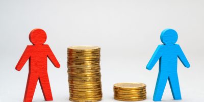 Successful businessman on a stack of coins. Big profit.