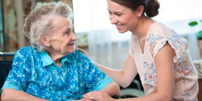 Senior woman with her caregiver at home