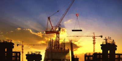 big crane and building construction against beautiful dusky sky use for construction industry and engineering