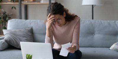 Unhappy young woman in glasses feeling stressed calculating monthly expenses at home, facing financial problems or lack of money for utility household or rental payments, bankruptcy concept.