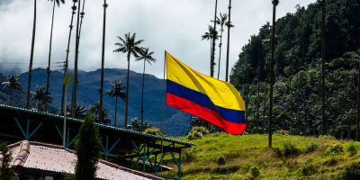 Colombian flag at the beautiful cloud forest and the Quindio Wax Palms at the Cocora Valley located in Salento in the Quindio region in Colombia.