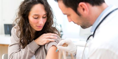 View of a Young attractive woman being vaccinated