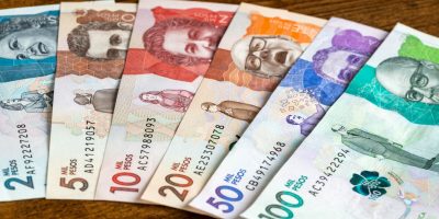 Colombian money, paper banknotes spread out on the table, banking and financial concept