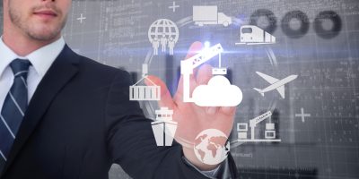 Focused businessman pointing with his finger against blue data