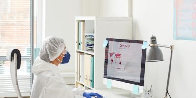 Doctor Examining The Statistics Of Covid DQSW7RJ