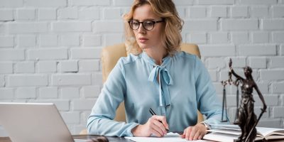 Serious Female Judge In Eyeglasses Working With Pa G8AJRDD