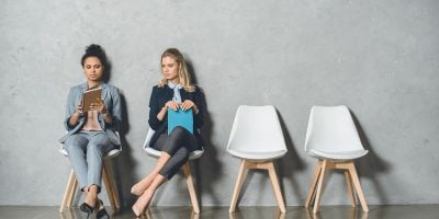Young Multicultural Businesswomen Sitting On Chair 2UPYPA2